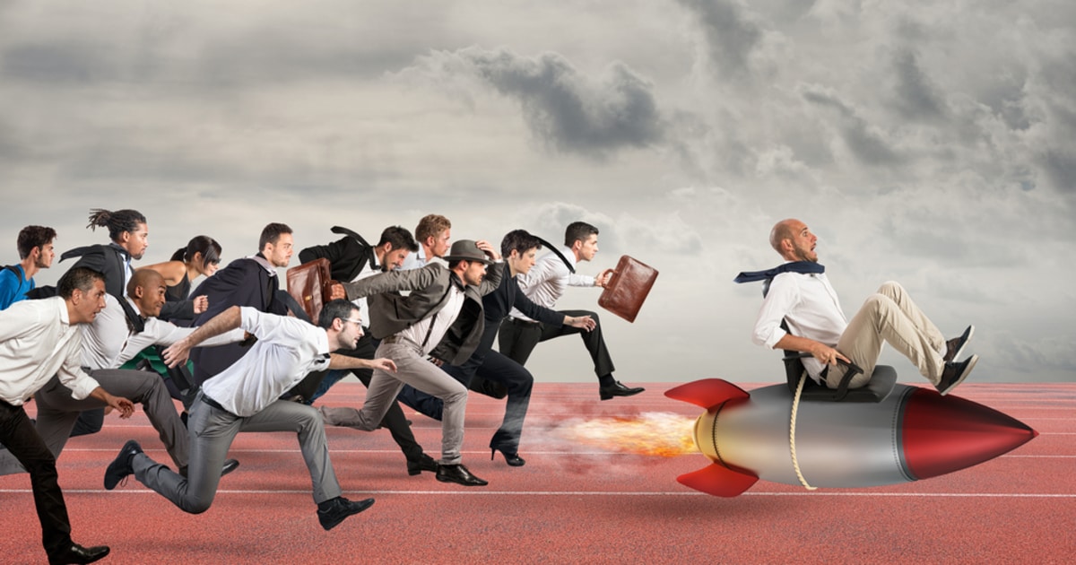Businessman symbolizing success riding a rocket and being chased by others