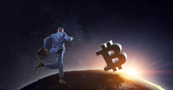 Businessman running towards Bitcoin perched on the moon
