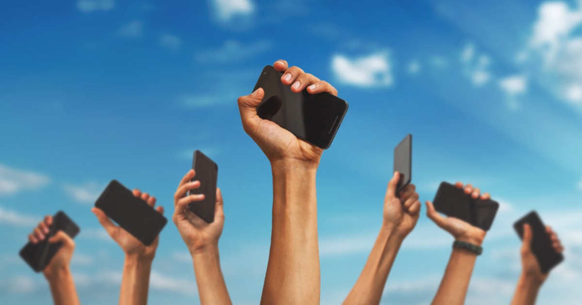 A display of smartphones being raised to the sky